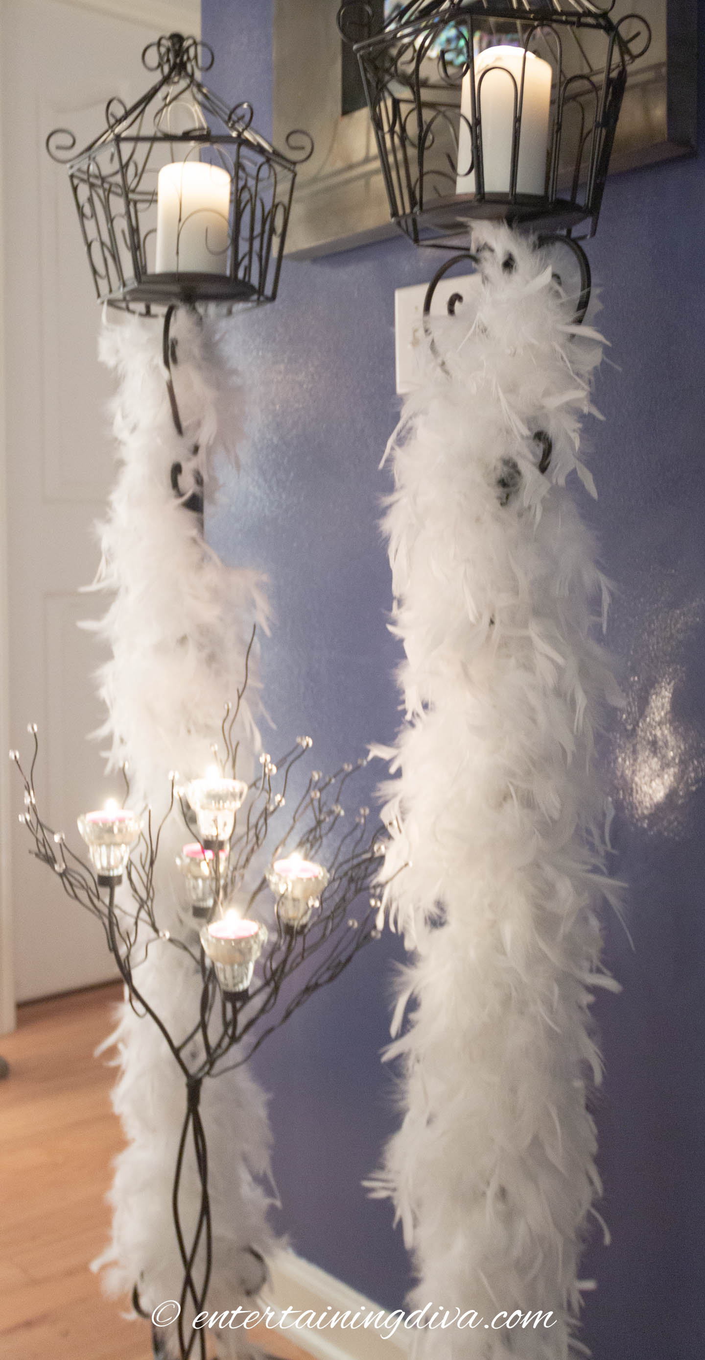 White feather boas wrapped around candle sticks