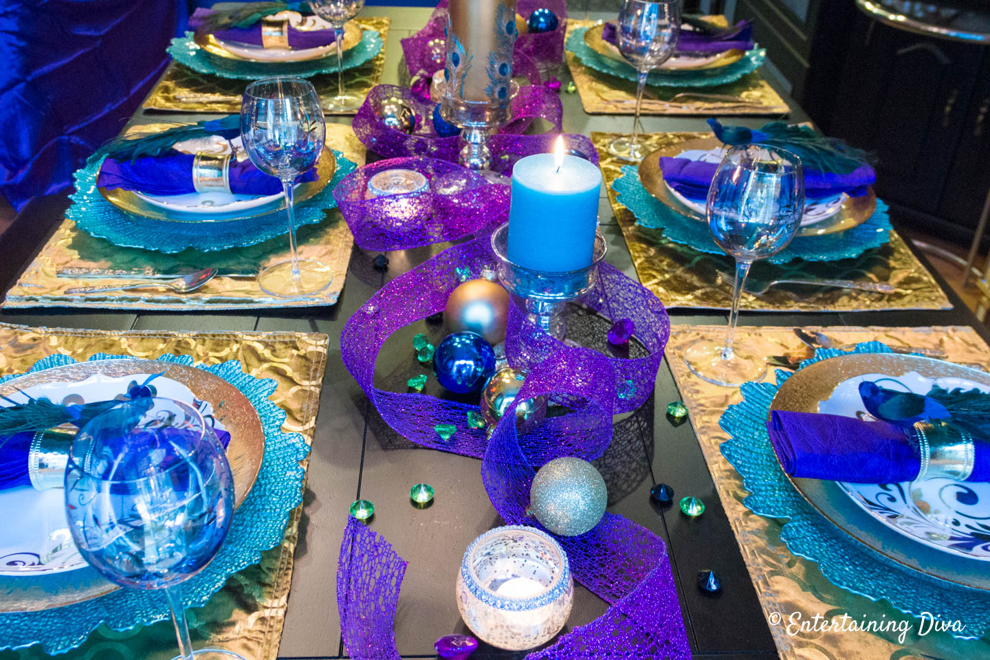 Mardi Gras table centerpiece made with purple, green and gold ribbon, ornaments and candles