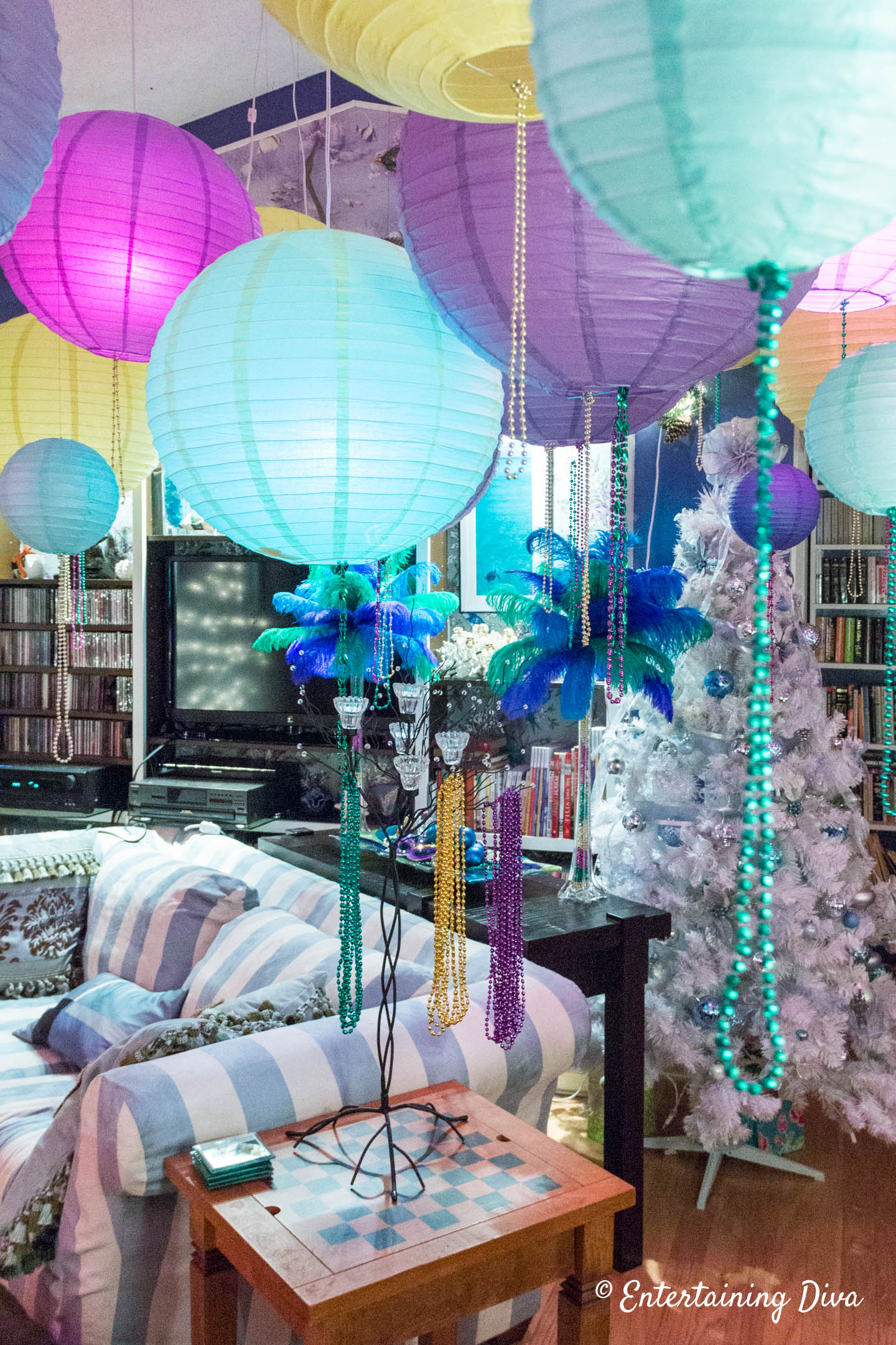 Mardi Gras party decorations with paper lanterns and beads