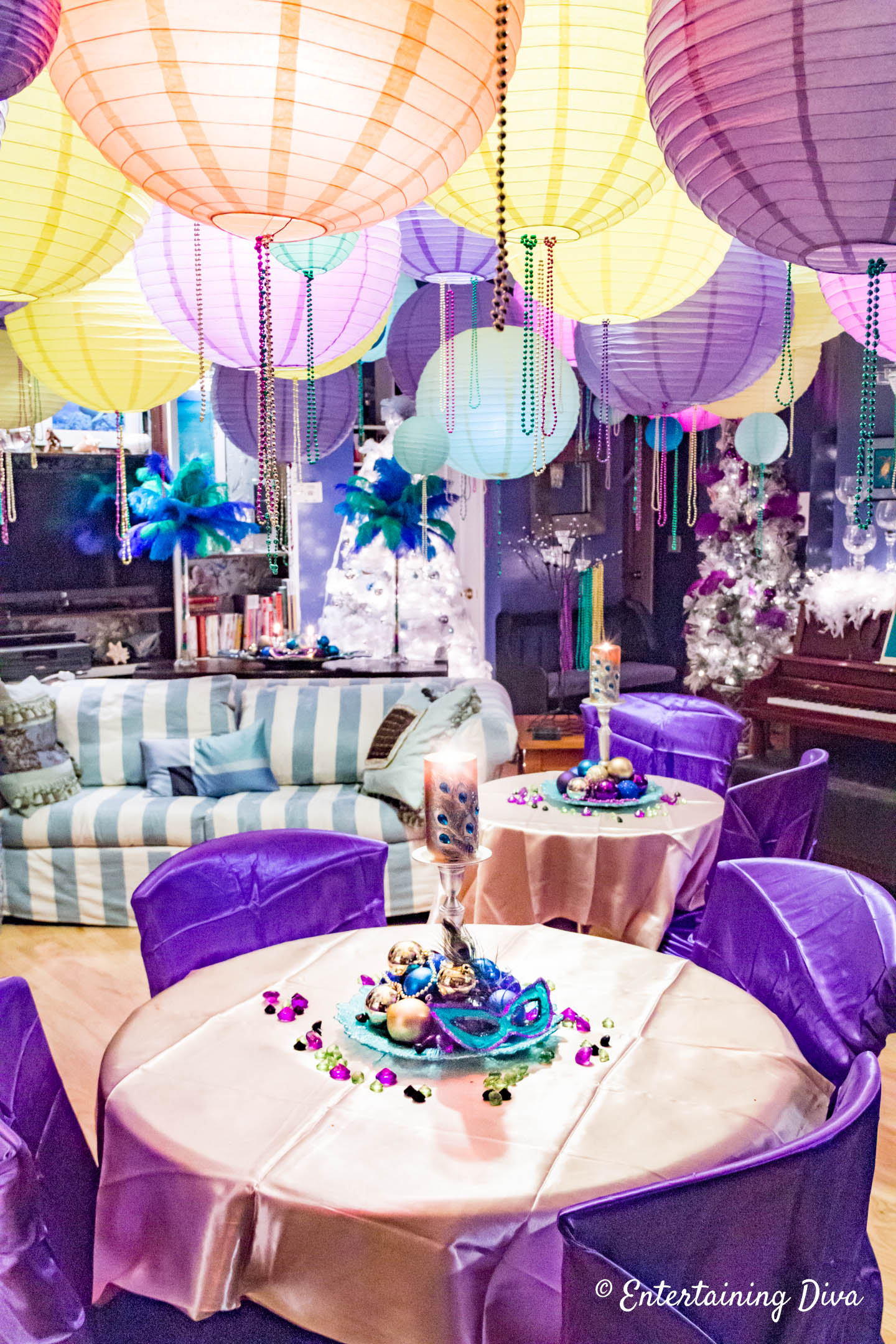 Mardi Gras room decorations with purple chair covers and gold tablecloths