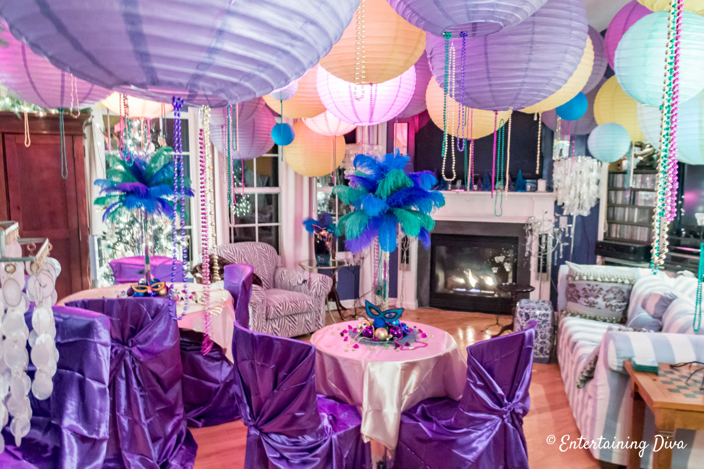 Mardi Gras party room decorations with beads and paper lanterns