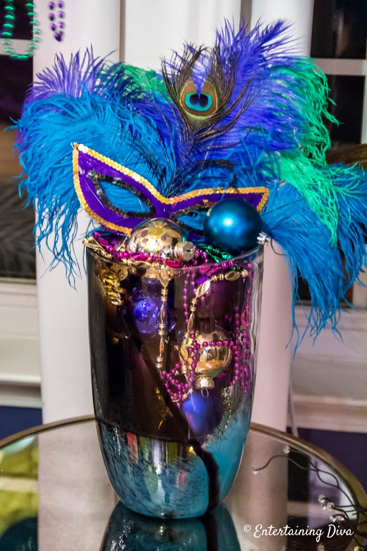Mardi Gras centerpiece in a vase with ostrich and peacock feathers