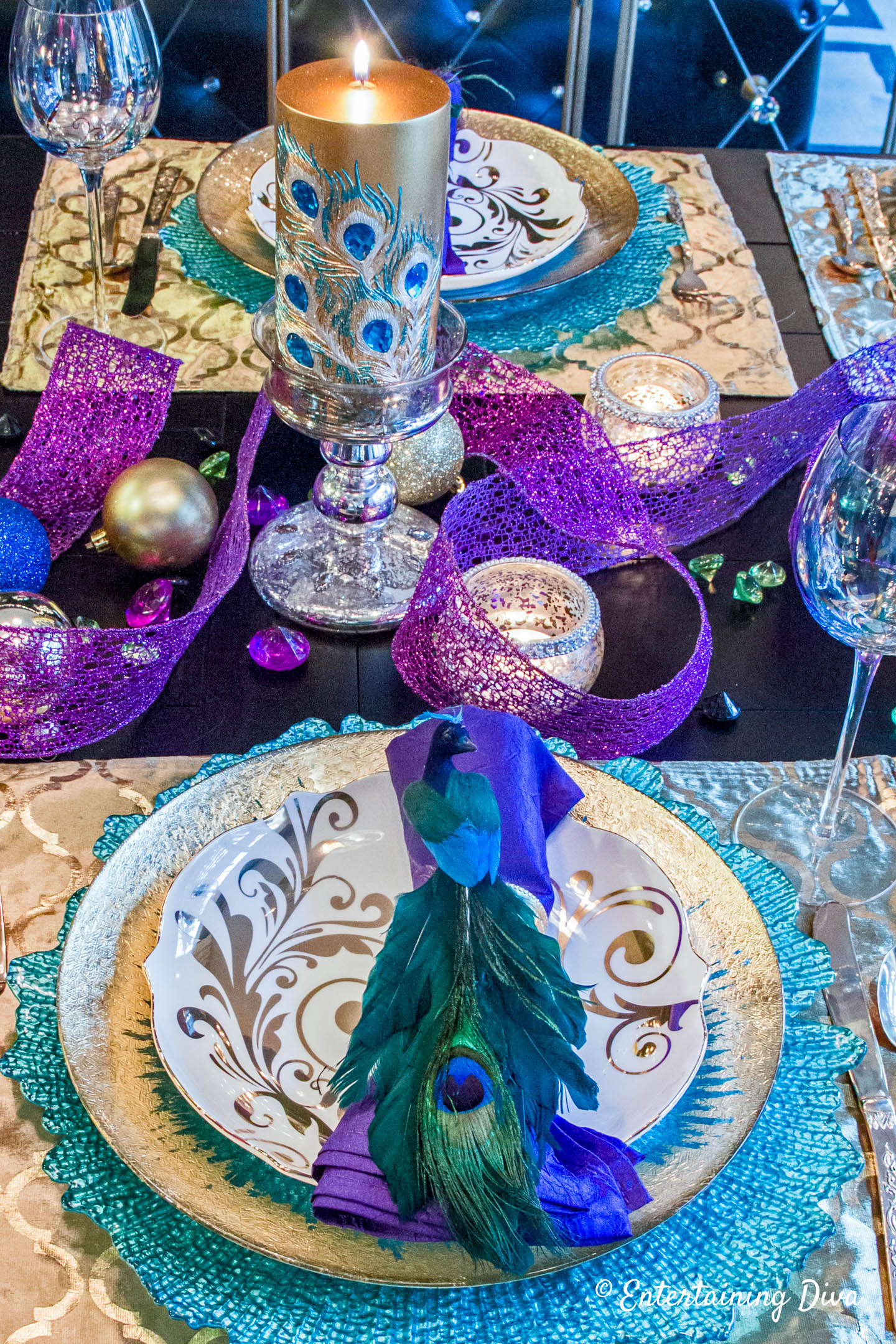 Peacock place setting and centerpiece on a Mardi Gras table setting