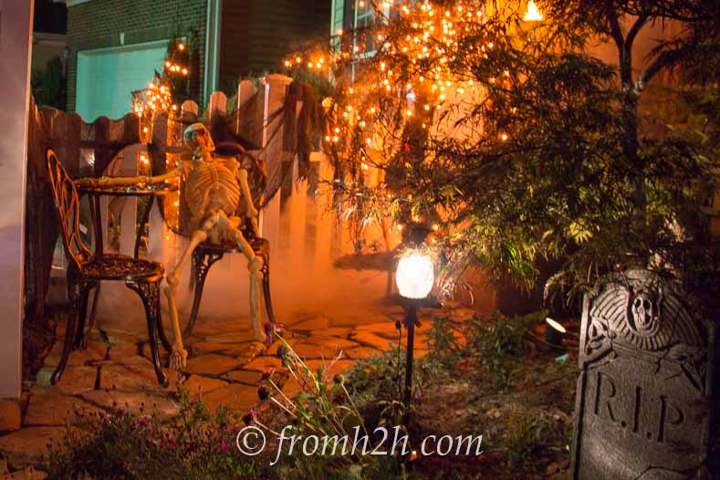 Halloween graveyard with orange lights and fog