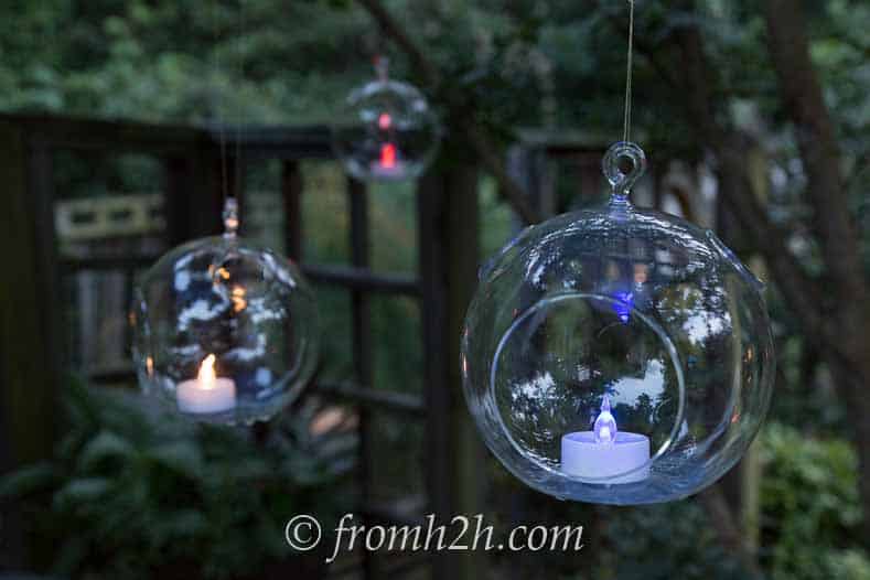 Red, white and blue tealights hanging from trees add to the July 4 patriotic decor