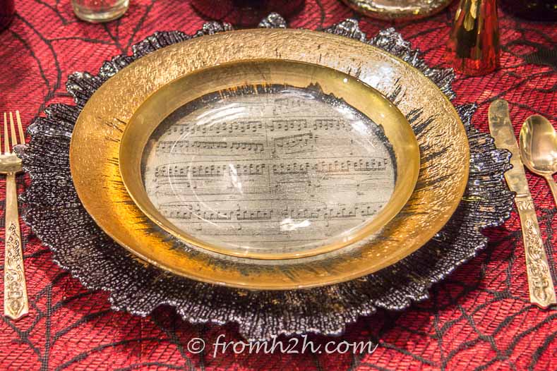 Gold-rimmed glass plates with sheet of music under it