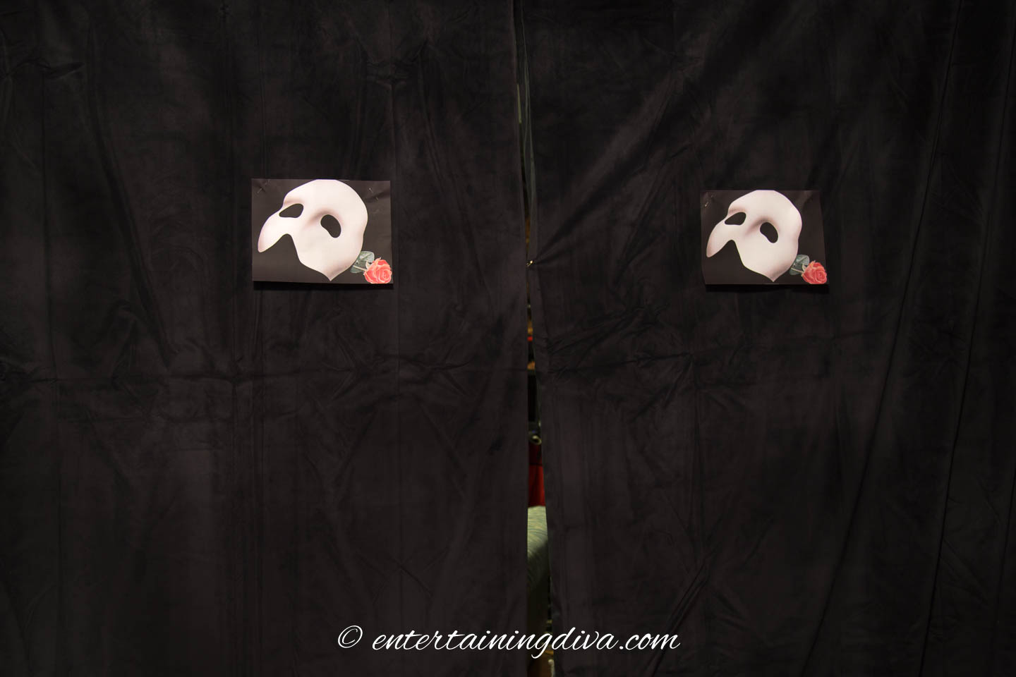 Black velvet curtains with Phantom of the Opera mask pictures on the front of them