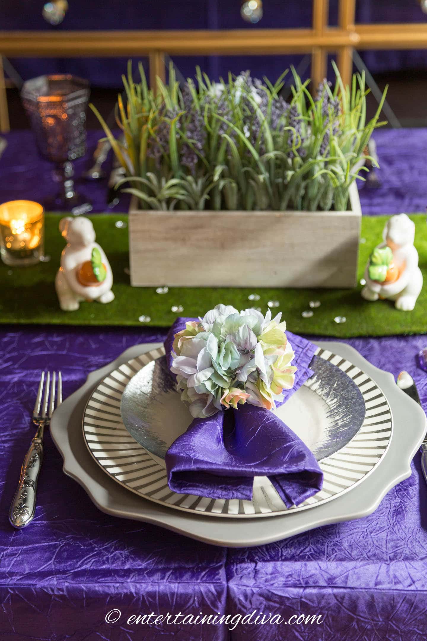Purple and green Easter place setting in front of a purple and green centerpiece