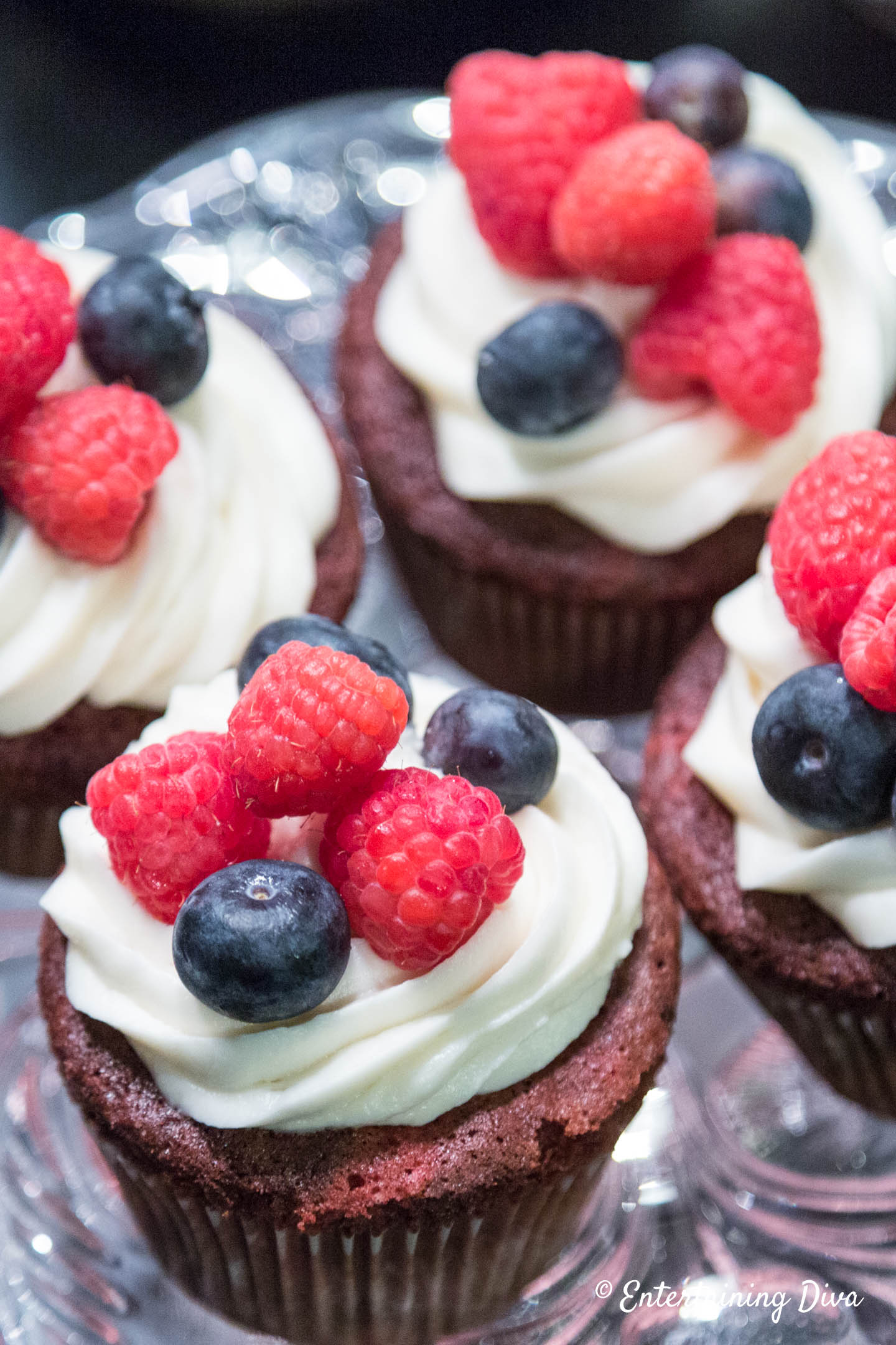 a slice of red velvet cake with traditional frosting