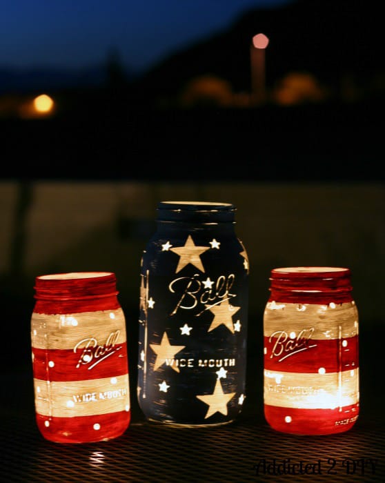 Patriotic Mason Jar Candleholders are another of the Easy Fourth Of July Ourdoor Decor Ideas