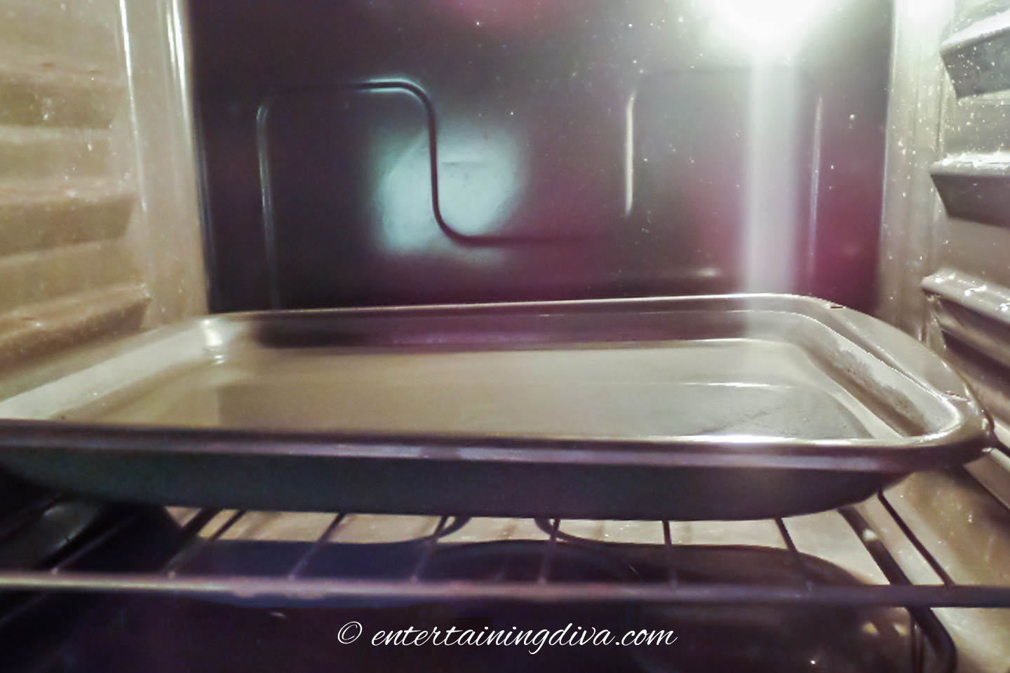 A shallow pan filled with water in an oven