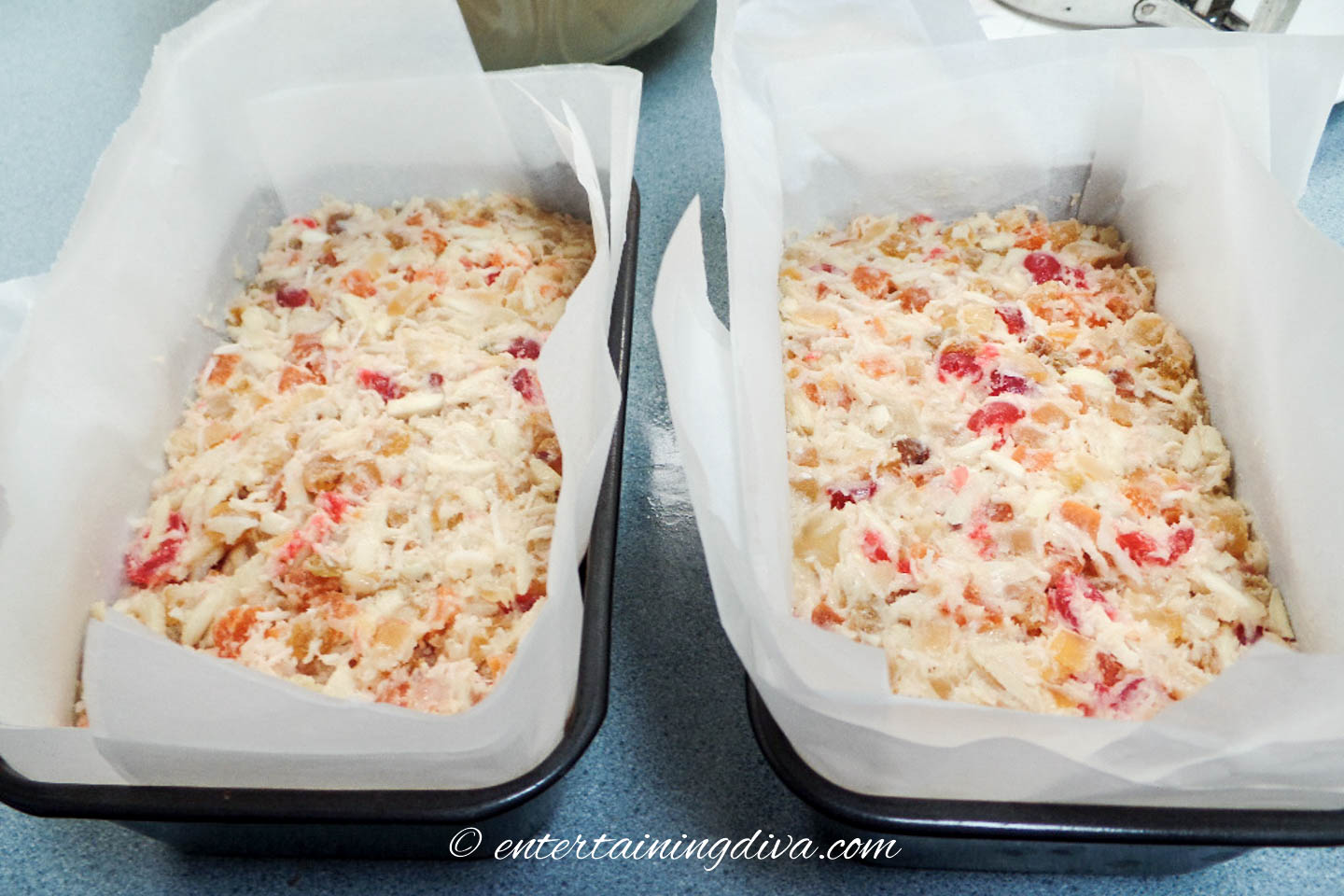 Baking pans filled with Christmas fruit cake batter