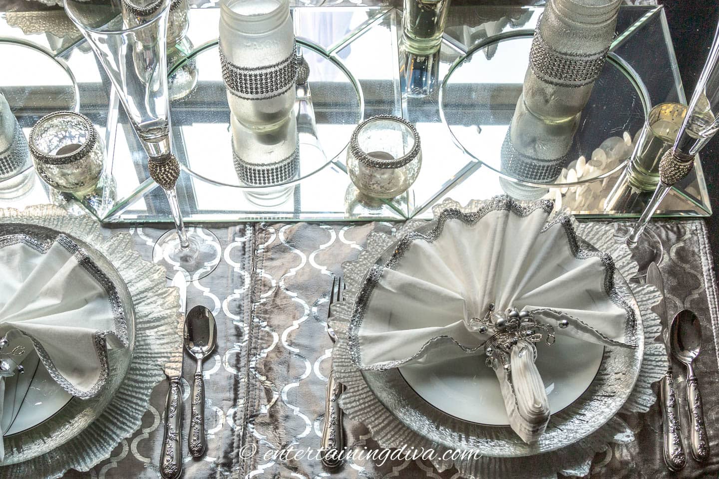 Cover the table with silver placemats and mirror chargers | Silver and White Winter Table Setting