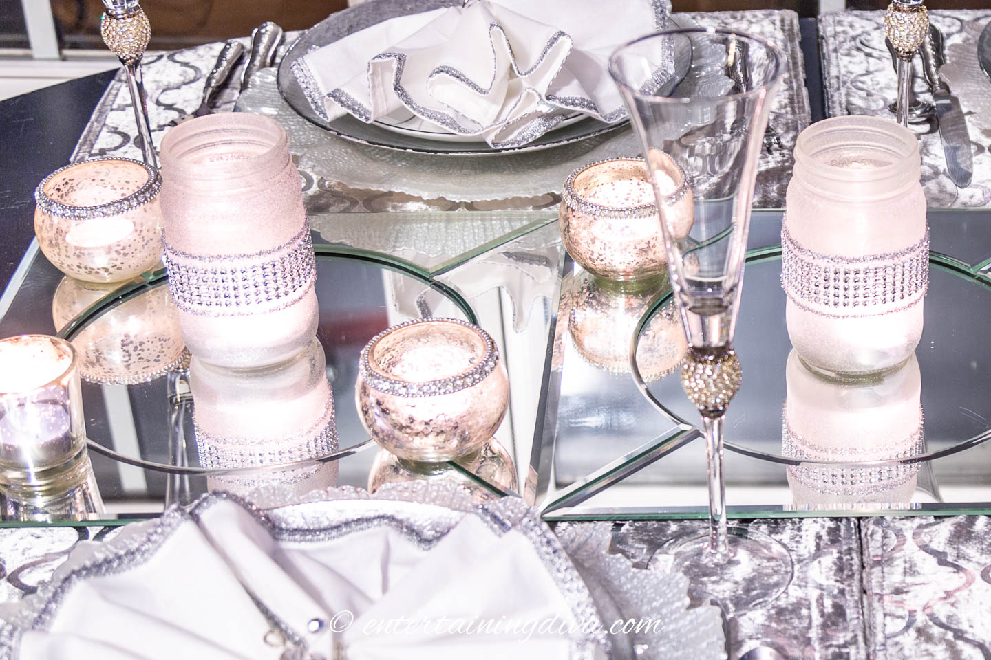 The candle light is reflected in the mirror chargers | Silver and White Winter Table Setting