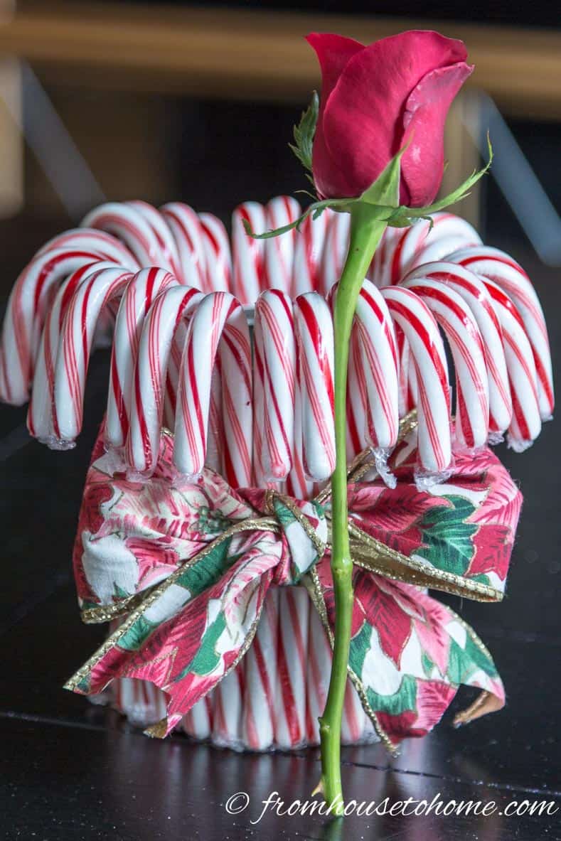 Cut the flowers a little taller than the height of the can | Add some holiday spirit to your Christmas table decor with this red and white DIY candy cane Christmas centerpiece! | DIY Quick and Easy Candy Cane Christmas Centerpiece