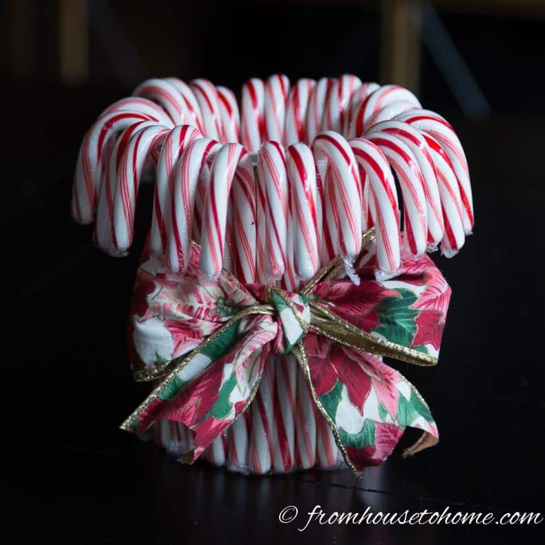 Tie a ribbon around the outside of the candy canes | Add some holiday spirit to your Christmas table decor with this red and white DIY candy cane Christmas centerpiece! | DIY Quick and Easy Candy Cane Christmas Centerpiece