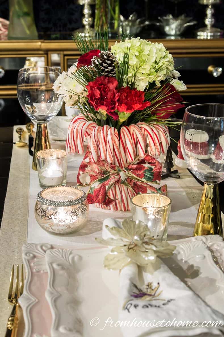 The centerpiece on the table | Add some holiday spirit to your Christmas table decor with this red and white DIY candy cane Christmas centerpiece! | DIY Quick and Easy Candy Cane Christmas Centerpiece