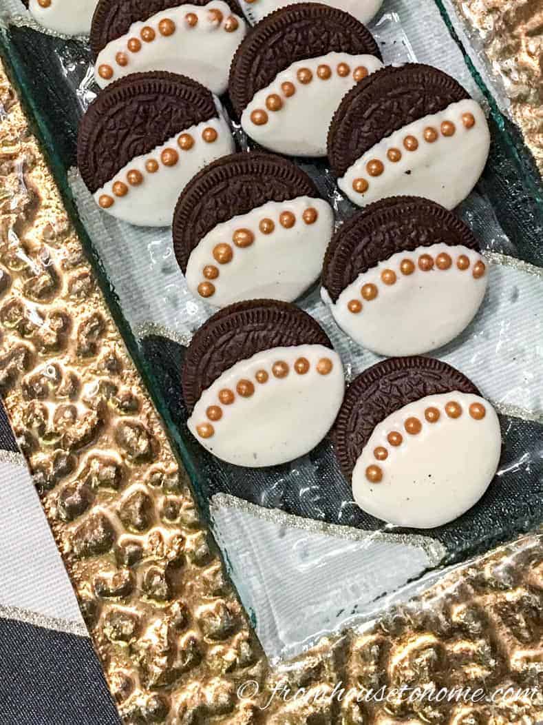 white chocolate covered Oreos with gold sugar ball trim