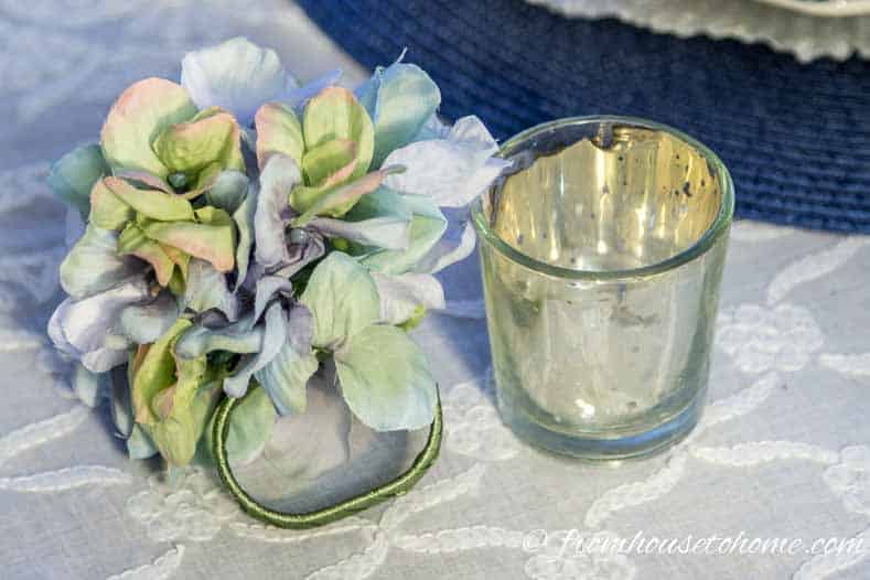 Place setting decorations are made from a candle holder and a napkin ring | Hydrangea-inspired Blue and White Tablescape | If you're looking for Easter dinner or spring table ideas, this blue and white table setting has a hydrangea centerpiece that is perfect for the occasion. The blue and white place setting is really pretty, too.