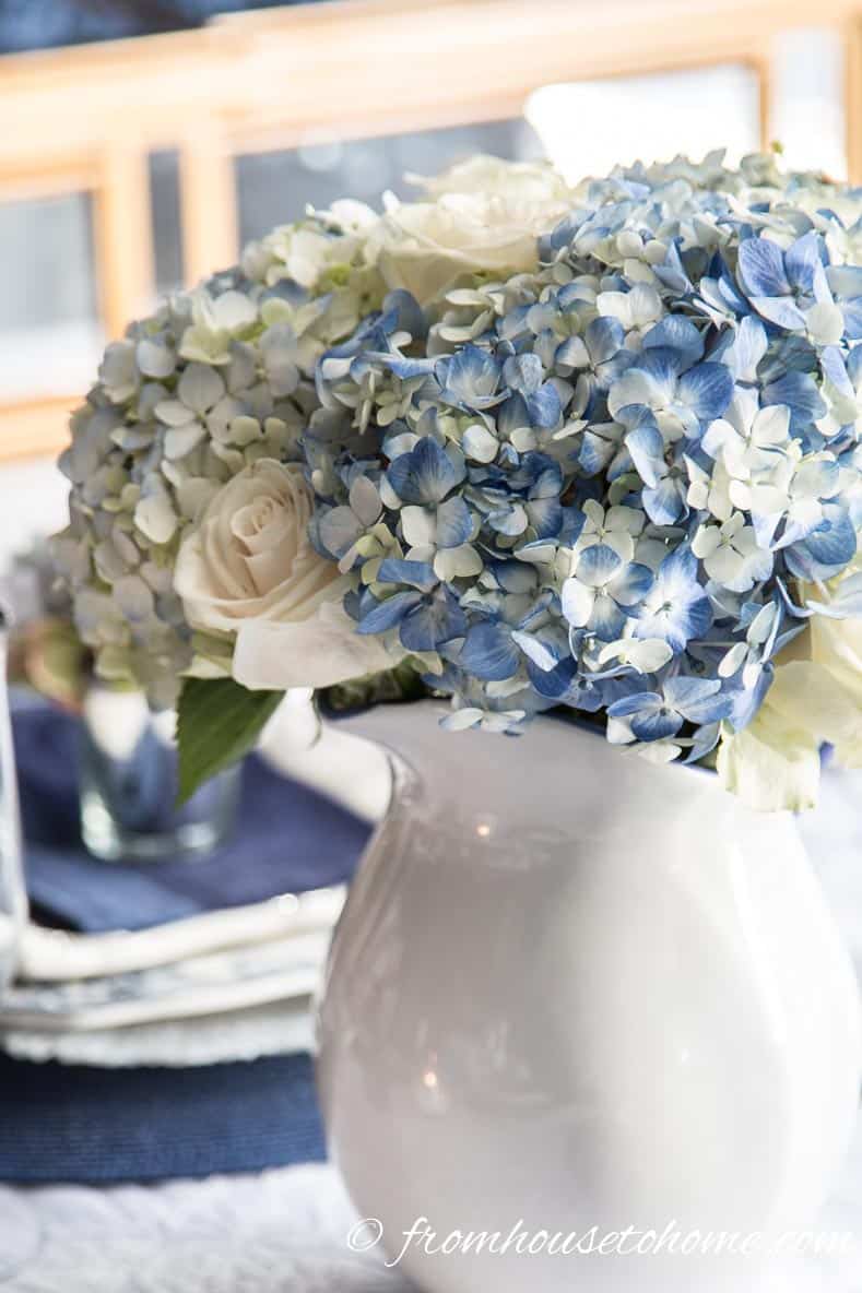 Hydrangea-inspired Blue and White Tablescape | If you're looking for Easter dinner or spring table ideas, this blue and white table setting has a hydrangea centerpiece that is perfect for the occasion. The blue and white place setting is really pretty, too.