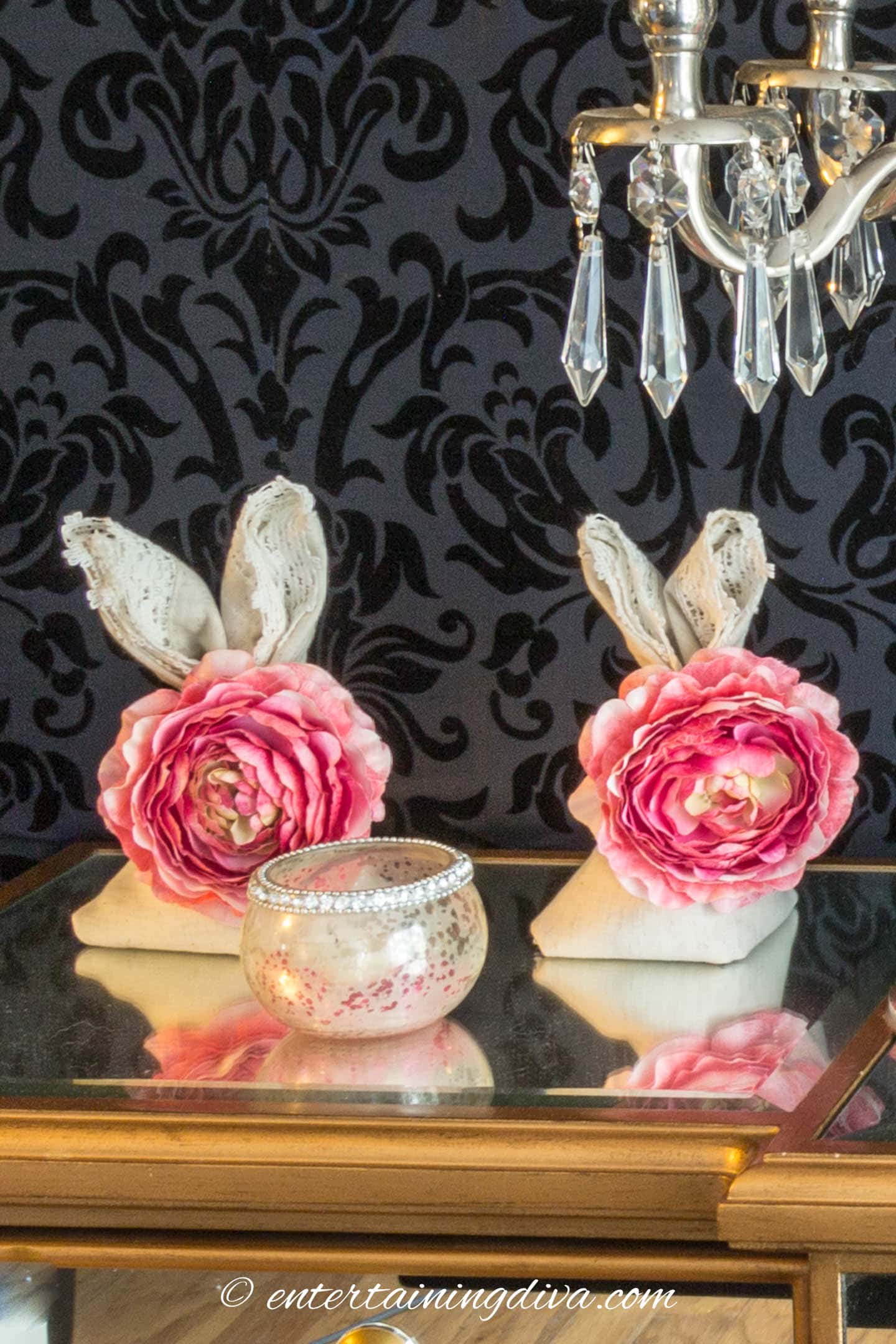 Two bunny folded napkins on a buffet