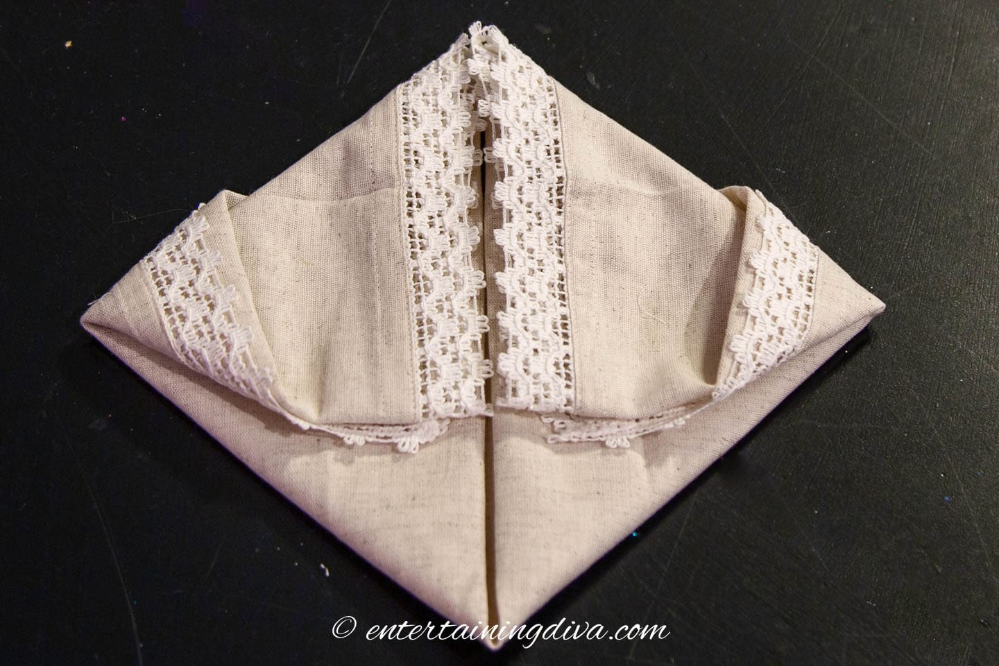 Napkin with the two top corners folded down
