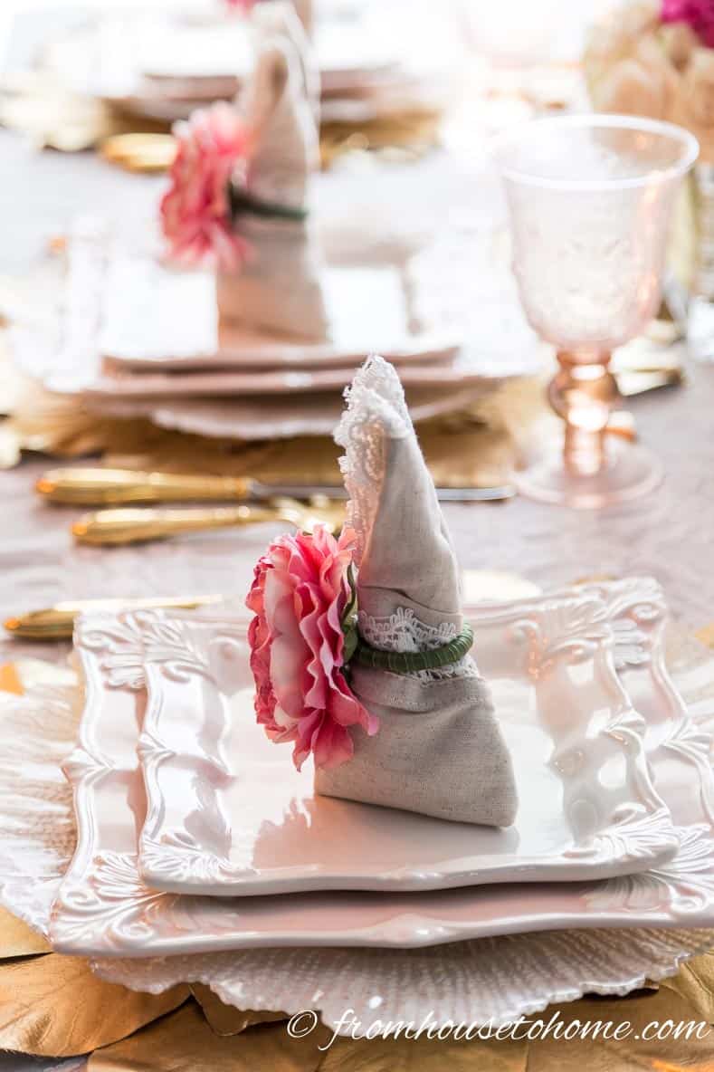 Side view of bunny folded napkins on a pink and gold Easter tablescape