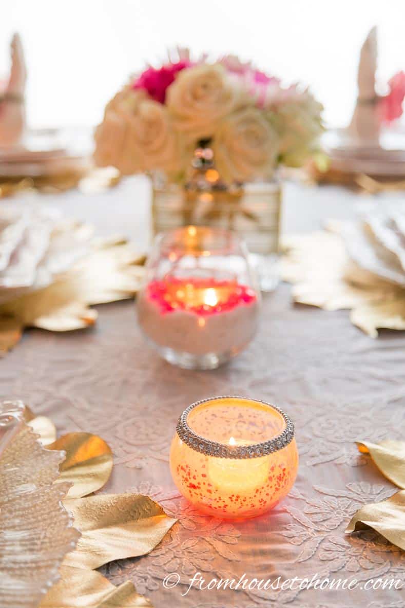 Candles in pink and white candleholders on the table