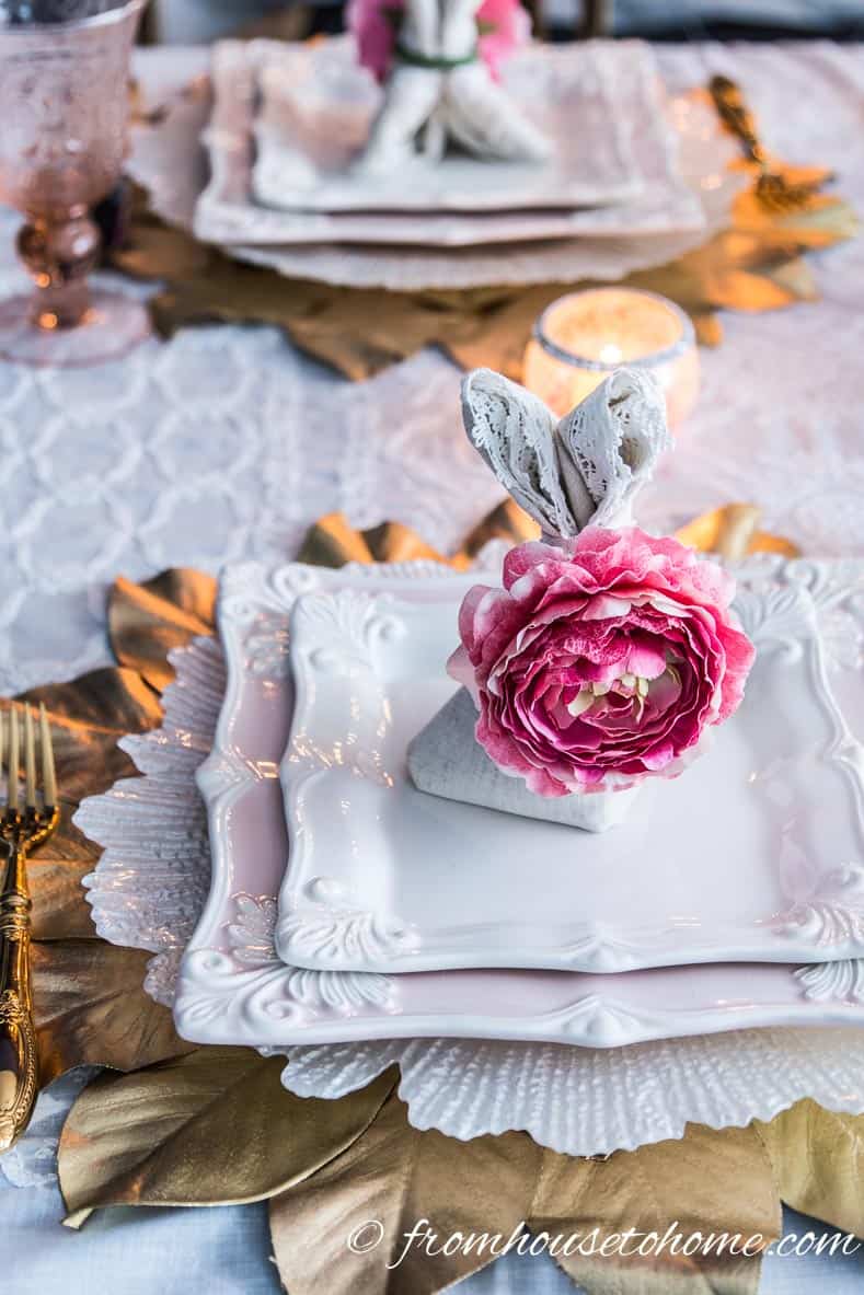 Bunny folded napkin on a pink and gold place setting