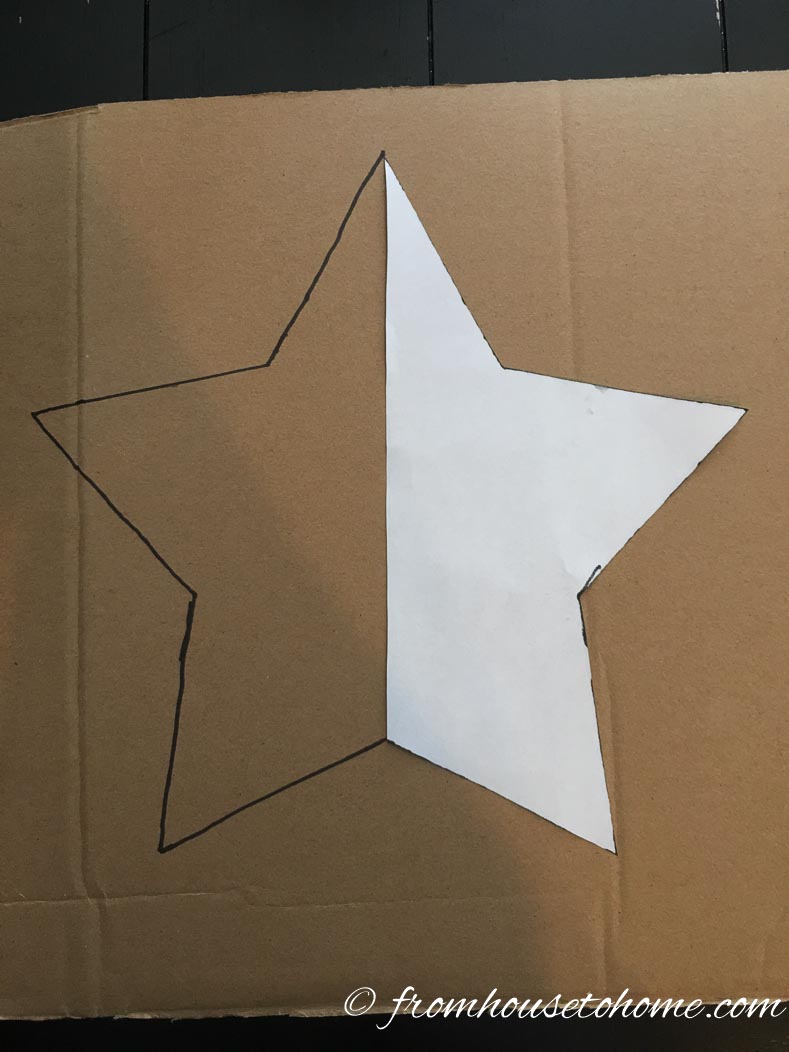 Star pattern being traced onto cardboard to make template for patriotic painted lawn decorations