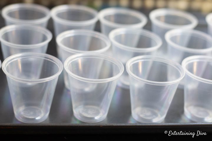 Empty jello shot cups on a cookie sheet