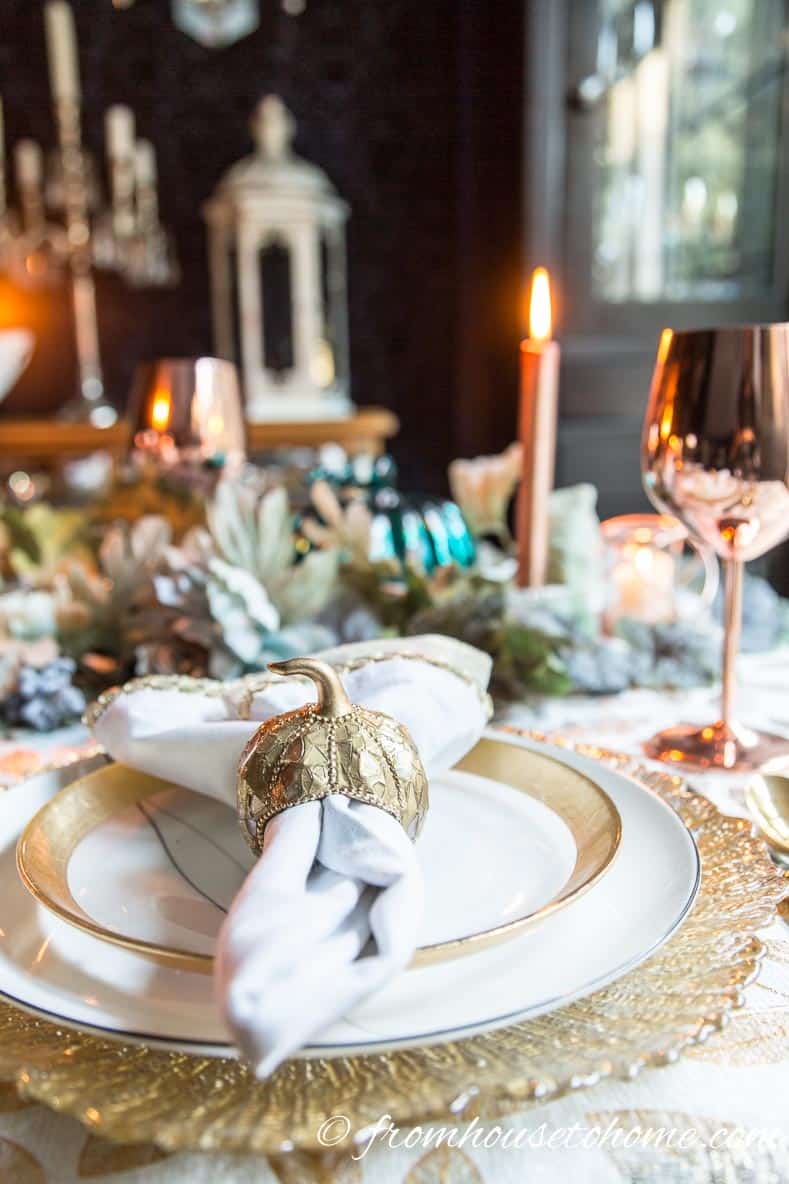 Gold and copper table setting with pumpkin napkin ring