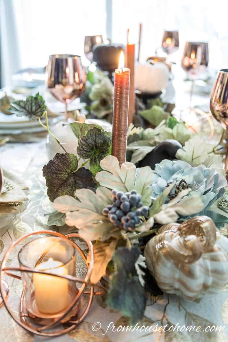 Copper candles in a leafy fall table centerpiece