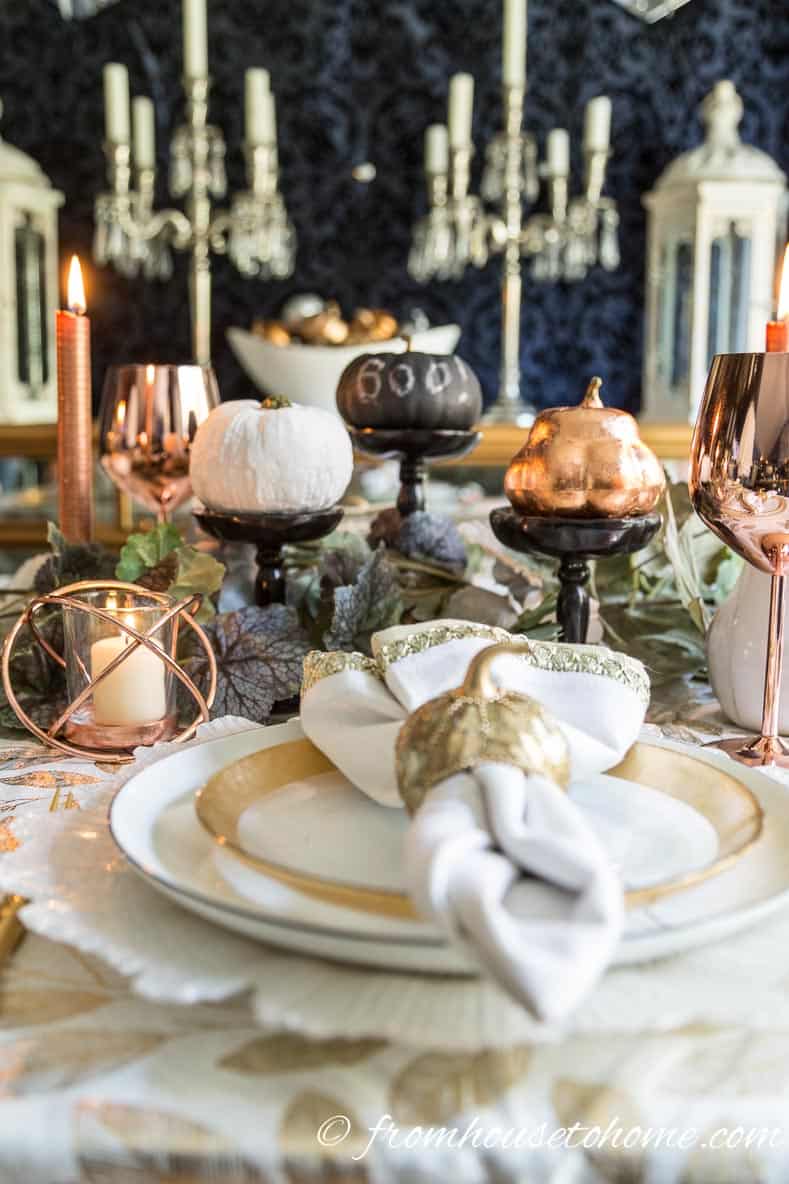 Copper fall table with white, black and copper mini pumpkins in the centerpiece
