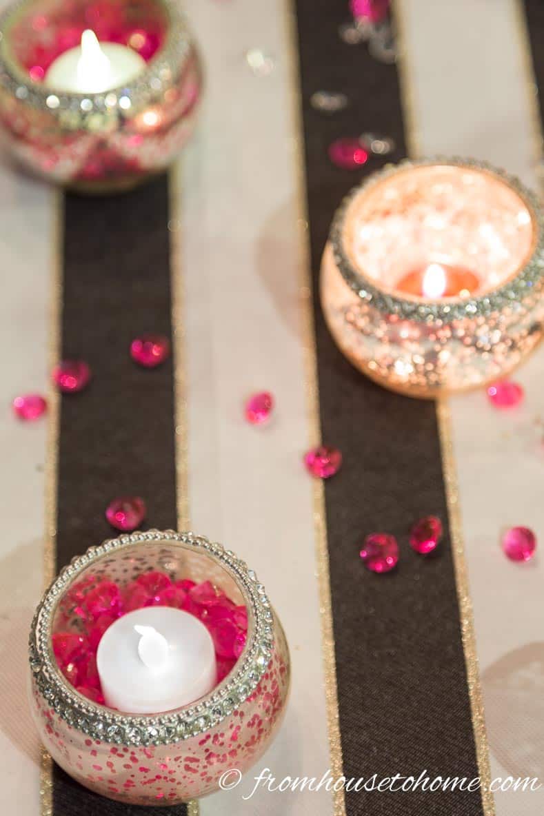 Valentine's Day Table Decoration Ideas with pink crystals sprinkled on a black and white tablecloth
