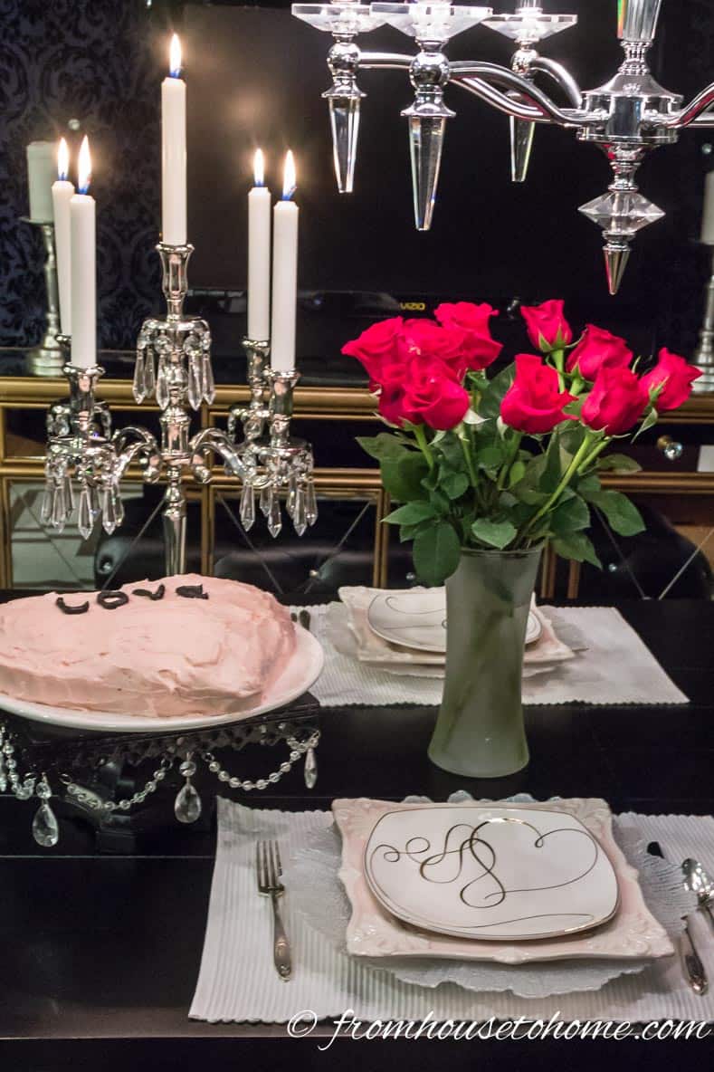Valentine's Day table decor with red roses, crystal chandelier and a heart shaped cake
