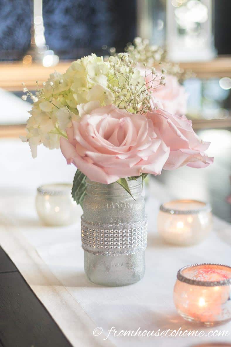 Floral arrangement made from pink roses, white hydrangeas and white baby's breath in a DIY mason jar vase