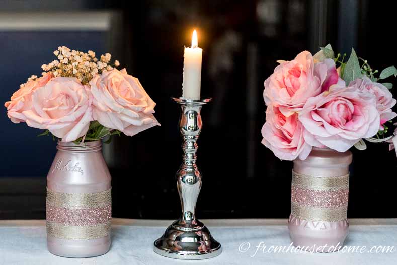 DIY rose gold centerpieces made from glass jars painted pink and filled with pink roses
