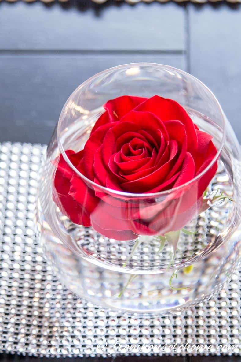 Valentine Day table decor idea with a red rose in a stemless wine glass