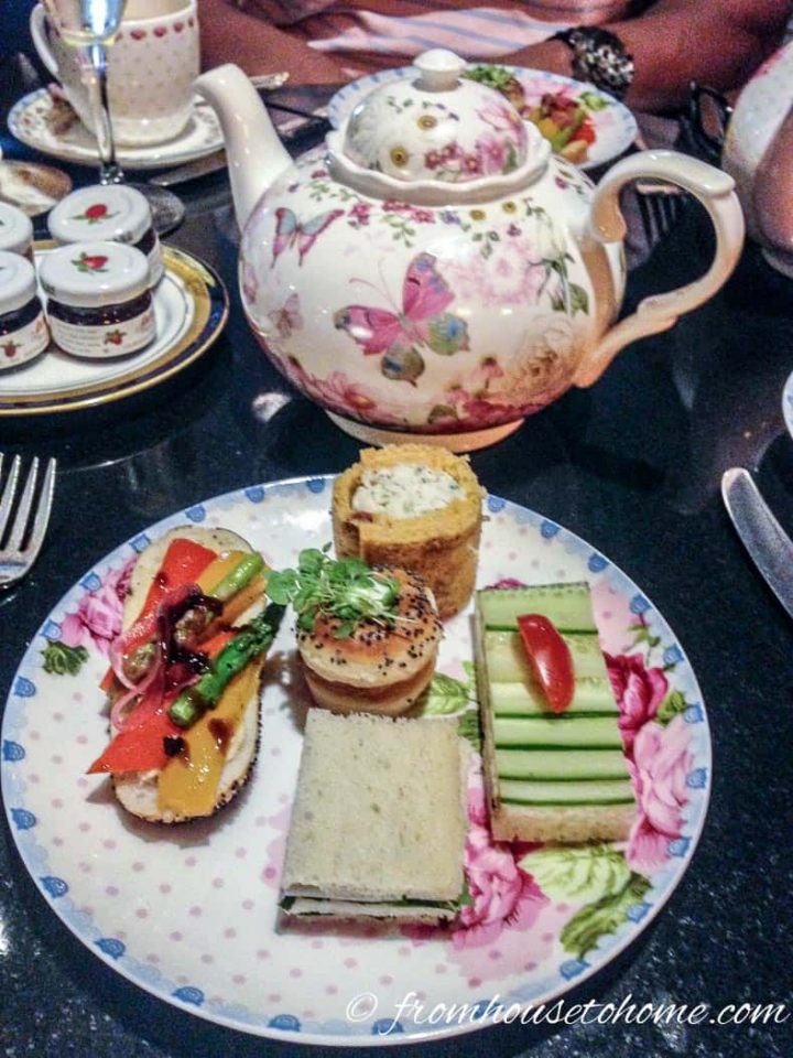 Tea party food on a plate with a teapot