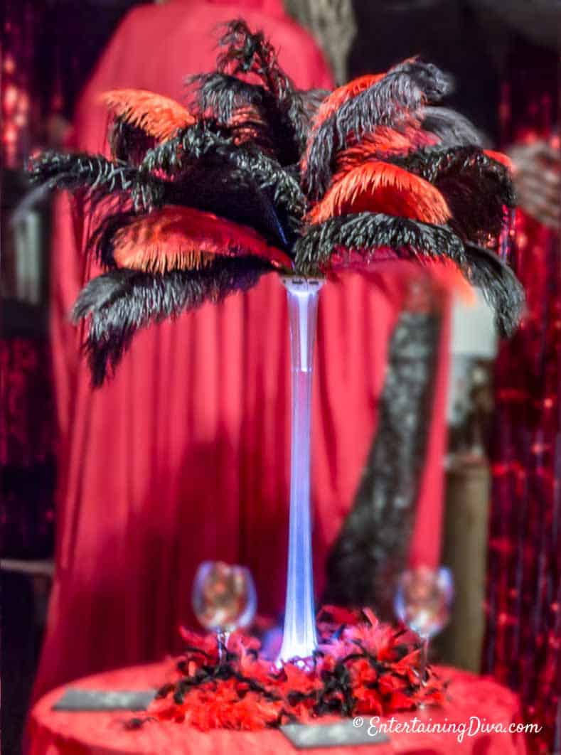 Black And Red Ostrich Feather Centerpiece with an uplight on the bottom