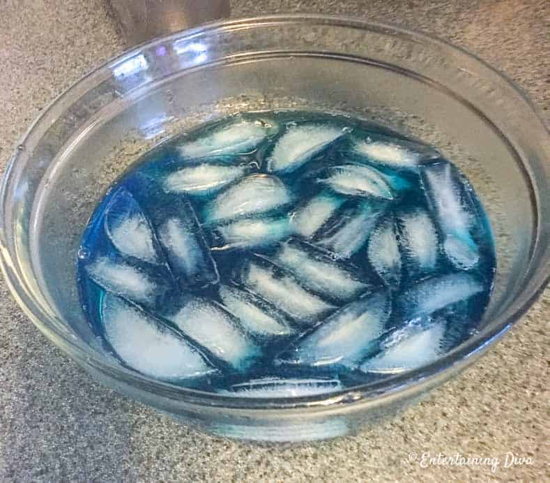 This 'under the sea' Swedish fish jello shot recipe with coconut rum is awesome! It is made with Malibu rum and is one of the best blue jello shots I've tried. #entertainingdiva #jelloshots #cocktailrecipe #summerfun #partyideas Add the alcohol and ice mixture to the berry blue jello