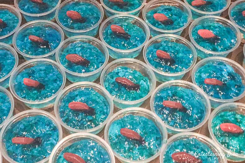 This 'under the sea' Swedish fish jello shot recipe with coconut rum is awesome! It is made with Malibu rum and is one of the best blue jello shots I've tried. #entertainingdiva #jelloshots #cocktailrecipe #summerfun #partyideas Under the sea jello shots with Swedish fish