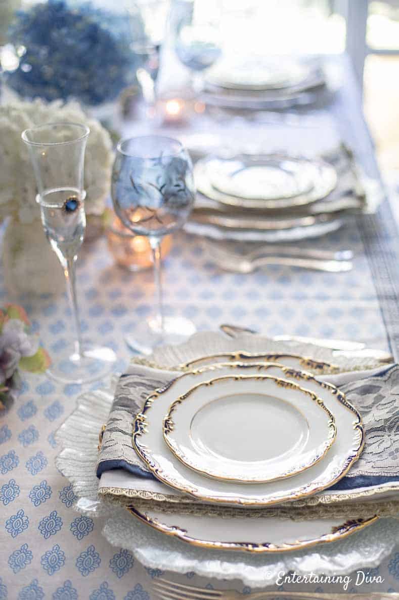 Blue and white place setting, napkins and wine glasses