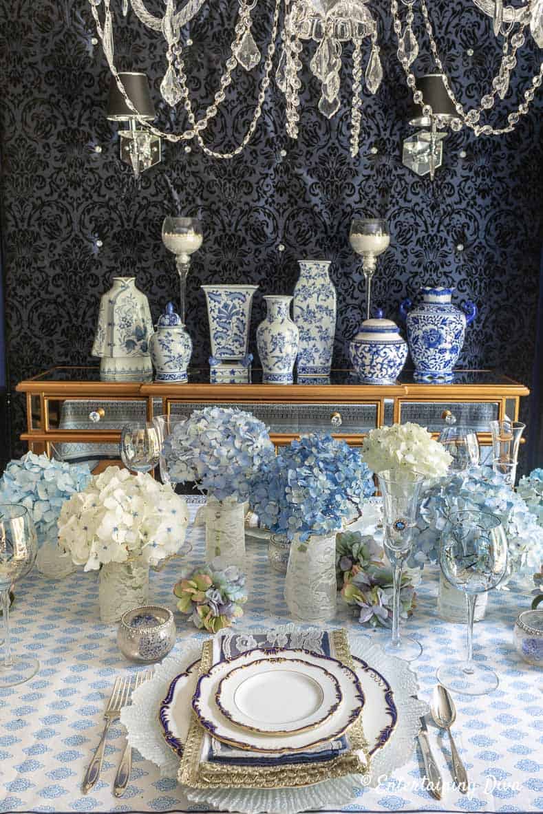 Blue and white summer table setting with blue and white Chinoiserie ginger jars on the buffet