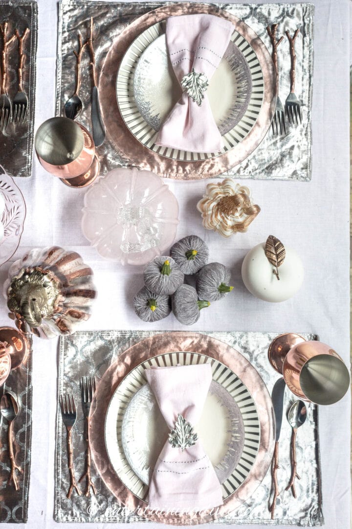 Pink, copper and silver place settings on a fall tablescape