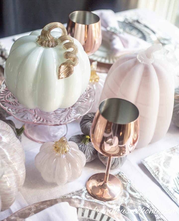 Pink and white glass pumpkins on cake stand