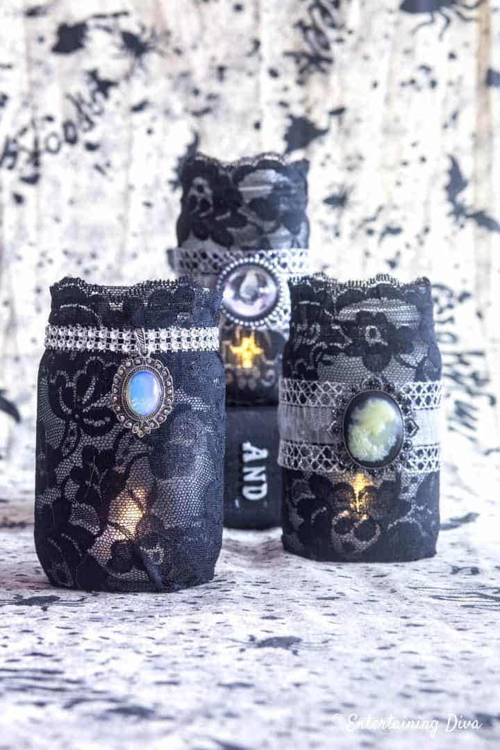 Halloween mason jar candle holders made with black lace and pendants