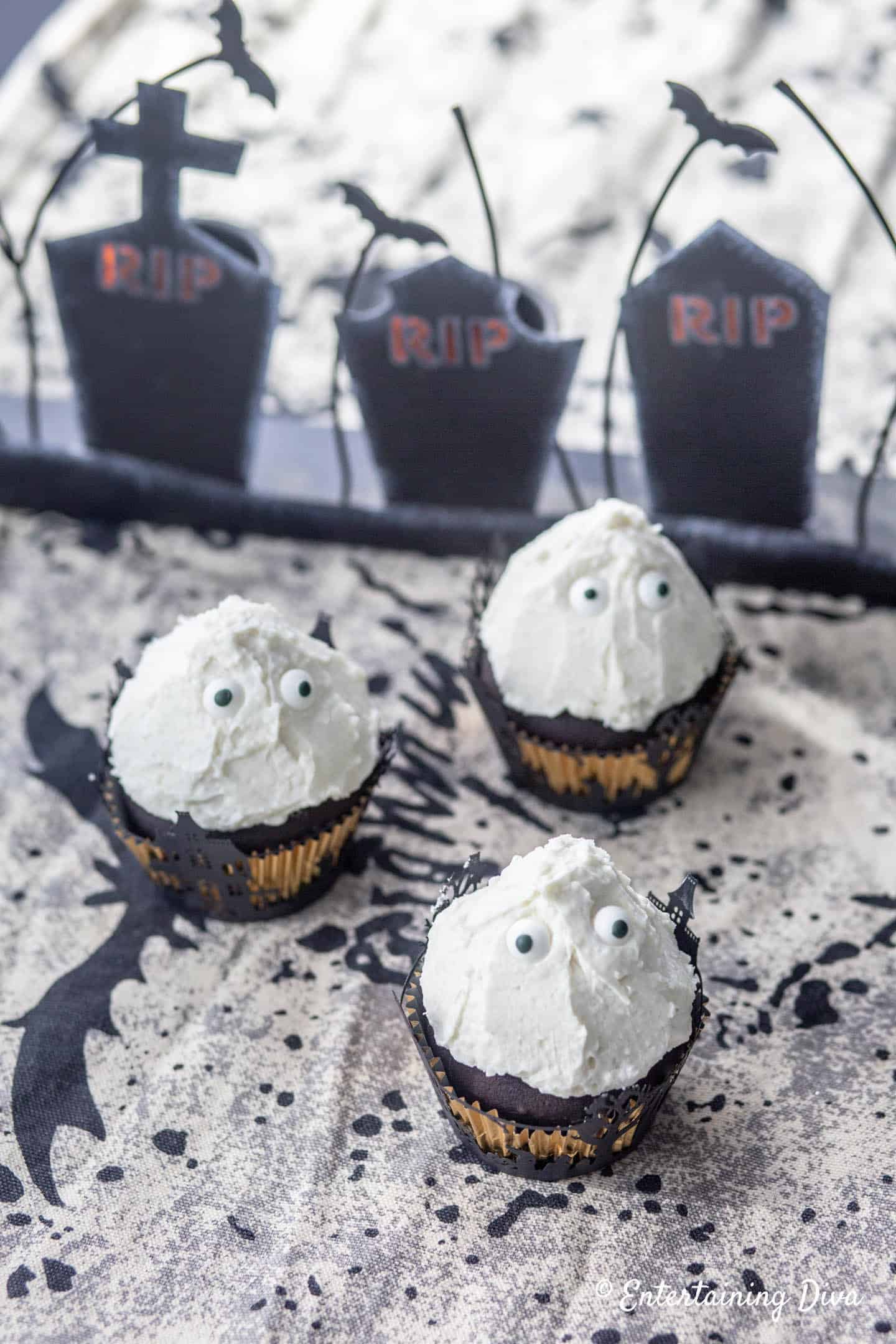 Halloween ghost cupcakes on a spooky tablecloth
