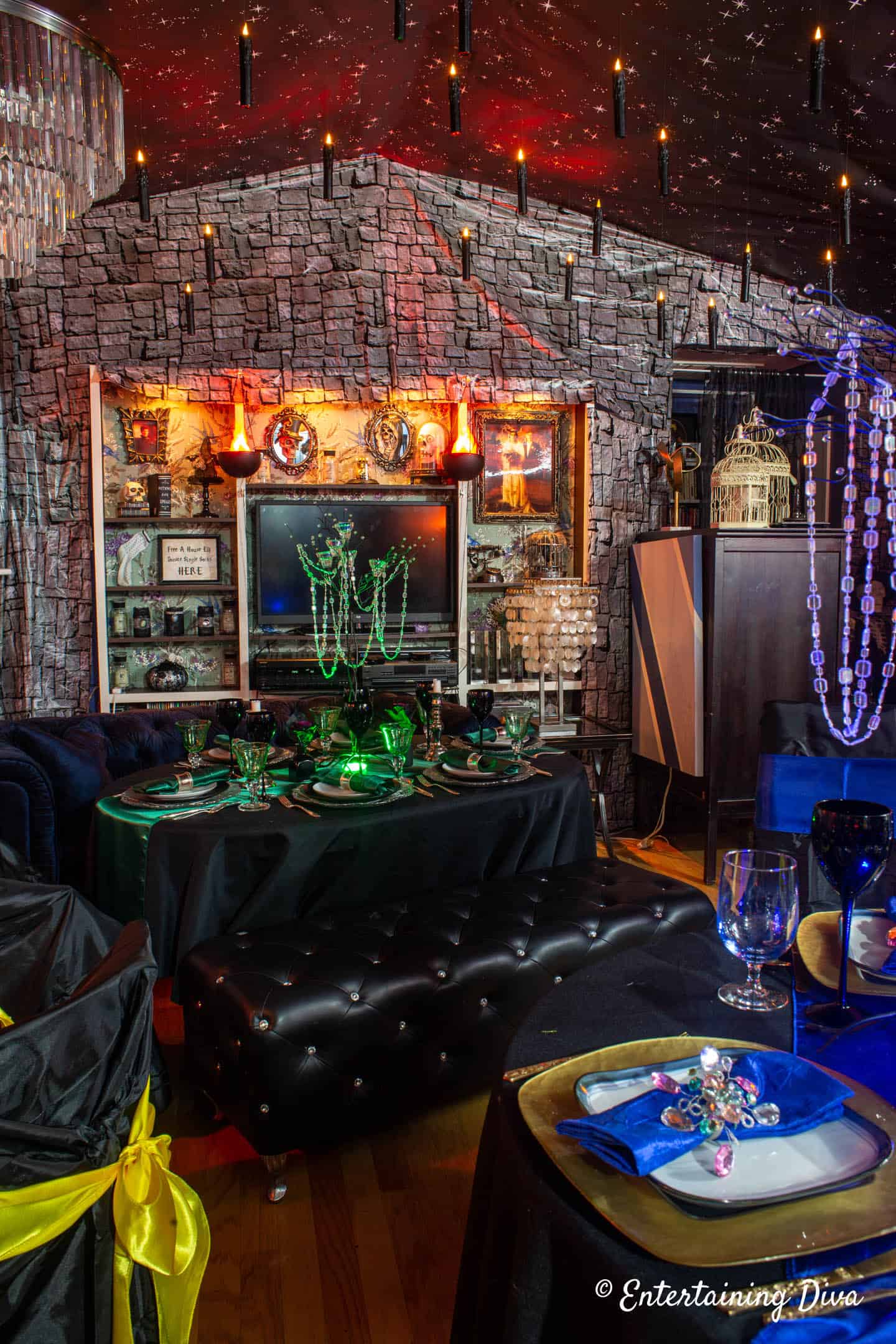 Great hall made with stone wall scene setters, floating candles and a Slytherin tablescape